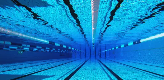 50 meter sports pool. Swimming pool underwater background.