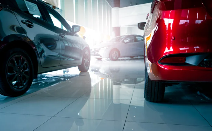 a-stylish-electric-car-parked-inside-a-luxury-dealership-office-where-customers-browse-and-rent-automobiles-in-a-modern-showroom-showcasing-clean-energy-technology-and-urban-transportation-innovation-stockpack-istock A stylish electric car parked inside a luxury dealership office where customers browse and rent automobiles in a modern showroom showcasing clean energy technology and urban transportation innovation.
