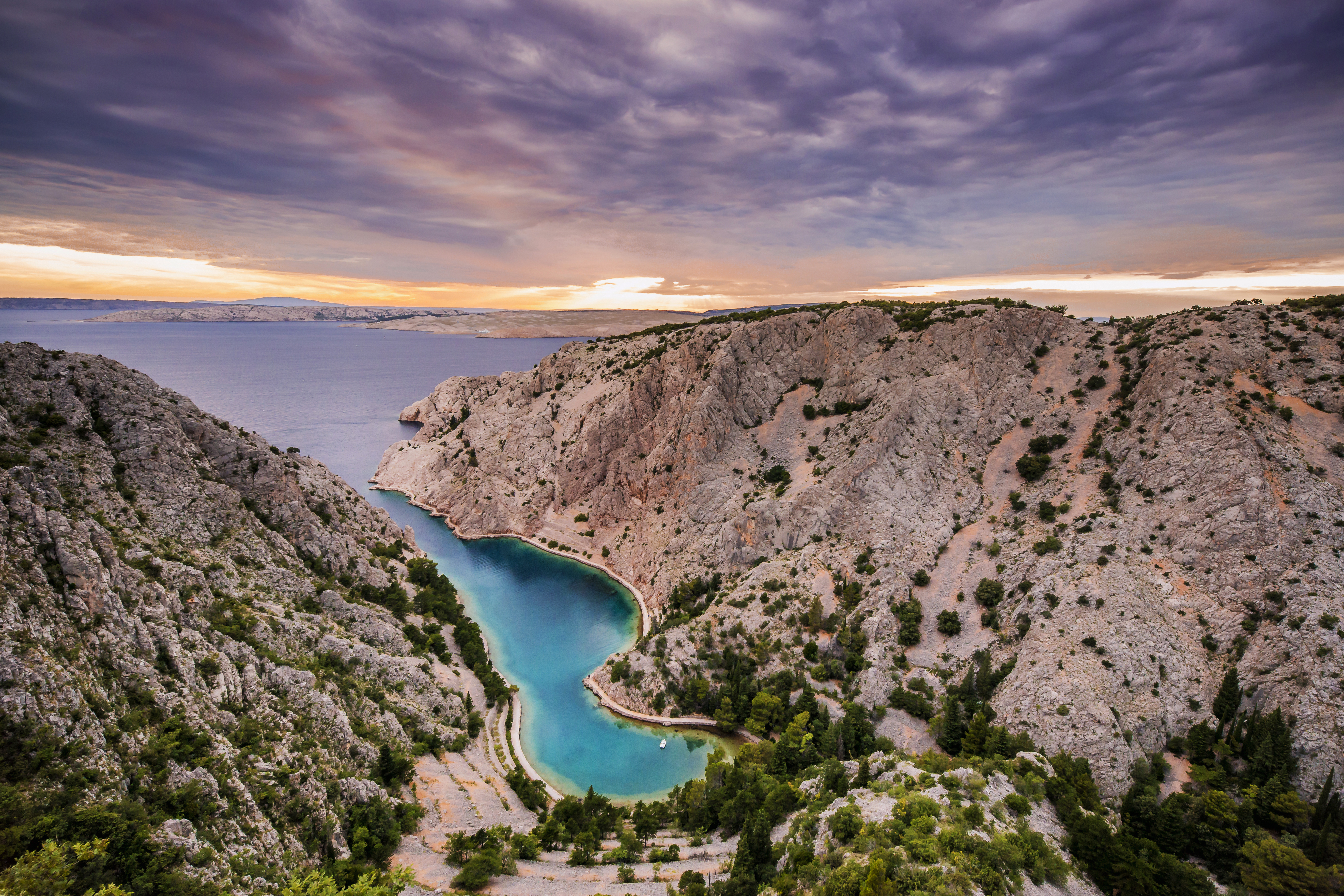 Beautiful sun sunset evening by the sea beach boat in mountains nature forest summer at Zavratnica bay, Croatia