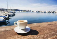 Skoraj 100 evrov za en dan na slovenski obali? Coffee cup on a table in a mediterranean cafe