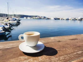 Skoraj 100 evrov za en dan na slovenski obali? Coffee cup on a table in a mediterranean cafe
