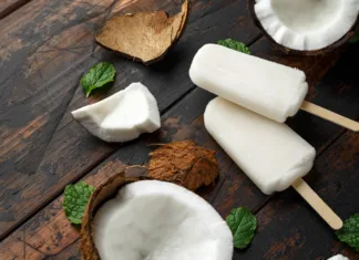 Pozabite na drage sladolede: Ta domači Bounty sladoled je hit poletja in stane le nekaj evrov Homemade coconut popsicles, ice lolly, on wooden table. Summer food