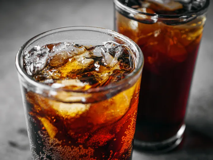 cola-soft-drink-with-ice-cubes-close-up-of-soda-fizzy-drink-in-cold-glass-on-gray-background-stockpack-istock Cola soft drink with ice cubes, Close up of soda fizzy drink in Cold glass on gray background