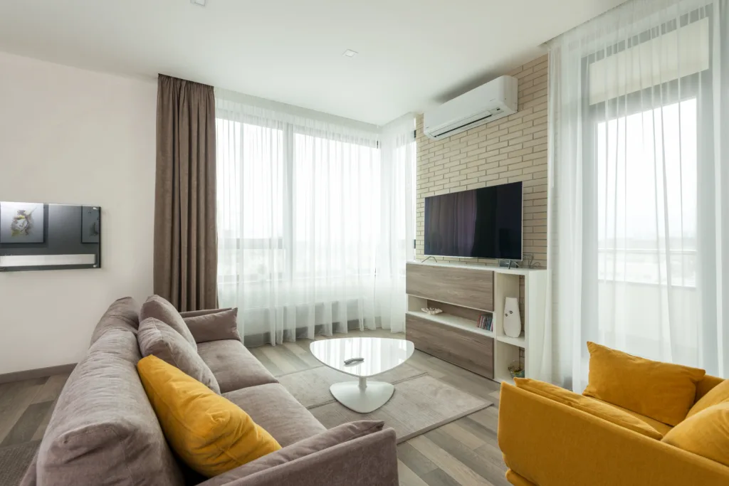 Cozy living room with comfy armchair and couch and modern tv set