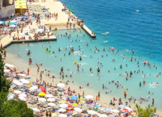Apartma že za 50 evrov na noč, kava za evro, kosilo pa za 5: to je verjetno najcenejša destinacija na Jadranu Neum, Bosnia and Herzegovina - July 16, 2017 : A view of the town waterfront and people swimming and sunbathing on the beach in Neum, Bosnia and Herzegovina.