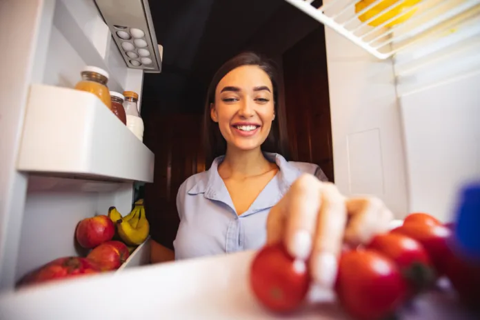 young-woman-taking-fresh-healthy-vegetables-from-refrigerator-view-from-fridge-stockpack-istock Young woman taking fresh healthy vegetables from refrigerator, view from fridge