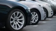 A lot of cars in a rows. Used car sales.