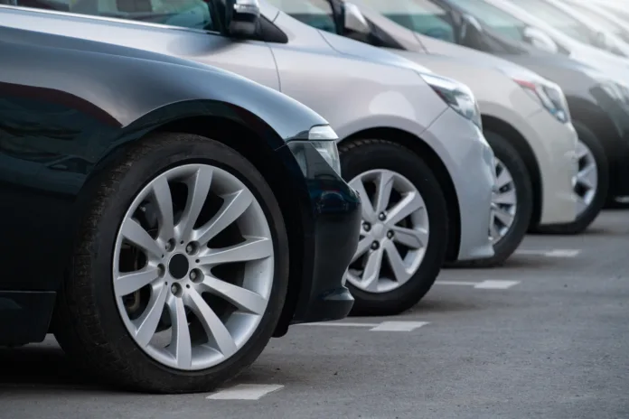 A lot of cars in a rows. Used car sales.