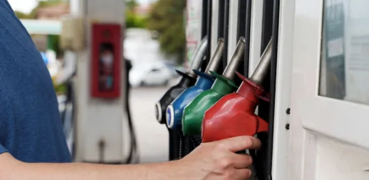 A man is filling ap car at a petrol station