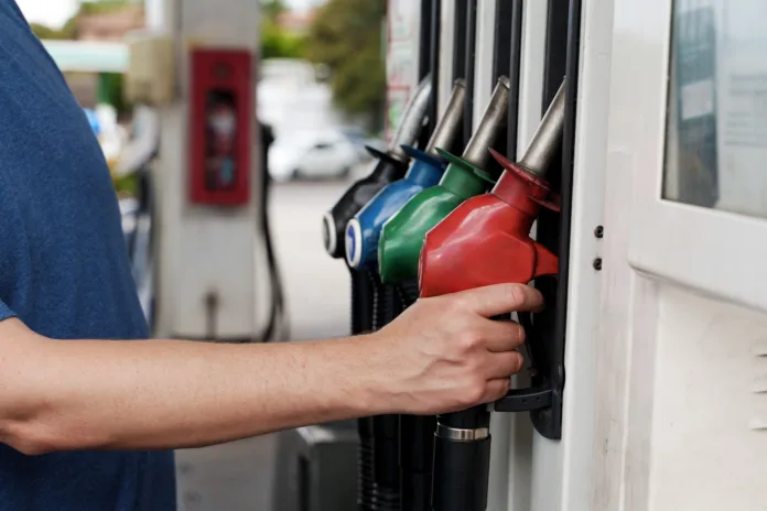 a-man-is-filling-ap-car-at-a-petrol-station-stockpack-istock A man is filling ap car at a petrol station