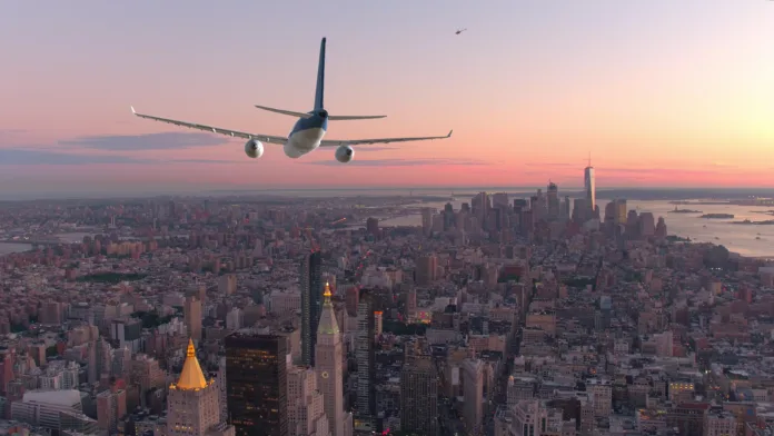 aerial-close-up-passenger-airplane-flying-over-breathtaking-downtown-manhattan-at-beautiful-sunset-massive-aircraft-flies-above-the-towering-modern-skyscrapers-in-new-york-city-at-idyllic-sunrise-stockpack-istock AERIAL, CLOSE UP: Passenger airplane flying over breathtaking downtown Manhattan at beautiful sunset. Massive aircraft flies above the towering modern skyscrapers in New York City at idyllic sunrise.