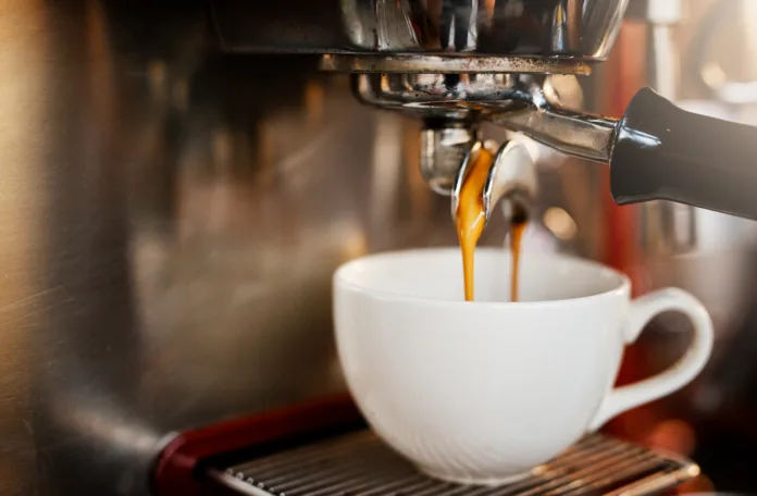closeup-shot-of-an-espresso-maker-pouring-coffee-into-a-cup-inside-of-a-cafe-stockpack-istock Closeup shot of an espresso maker pouring coffee into a cup inside of a cafe