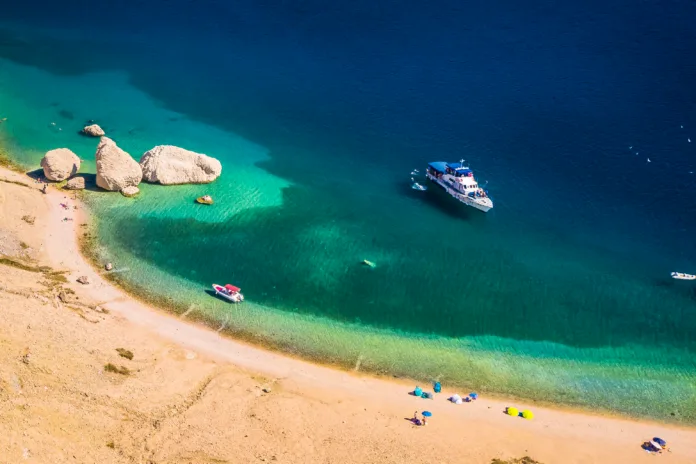drone-image-of-beritnica-beach-on-pag-island-showing-unique-rocky-formations-clear-turquoise-sea-barren-karst-terrain-and-a-dramatic-adriatic-coastal-landscape-in-bright-sunlight-stockpack-istock Drone image of Beritnica beach on Pag island showing unique rocky formations, clear turquoise sea, barren karst terrain and a dramatic Adriatic coastal landscape in bright sunlight
