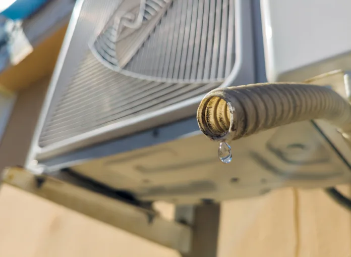 Water dripping from the drain pipe of the outdoor unit of the air conditioner.