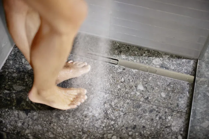 2026_Bathroom_CleanLine30_with_model_closeup_feet_wet
