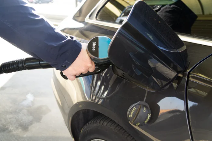a-man-at-a-gas-station-is-refueling-a-diesel-car-with-diesel-fuel-stockpack-istock A man at a gas station is refueling a diesel car with diesel fuel.