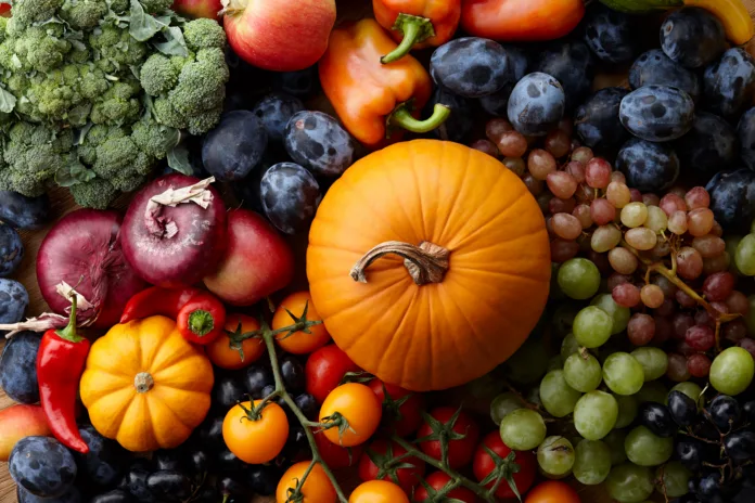 autumn-harvest-concept-seasonal-fruits-and-vegetables-on-a-wooden-table-top-view-stockpack-istock Autumn harvest concept. Seasonal fruits and vegetables on a wooden table, top view