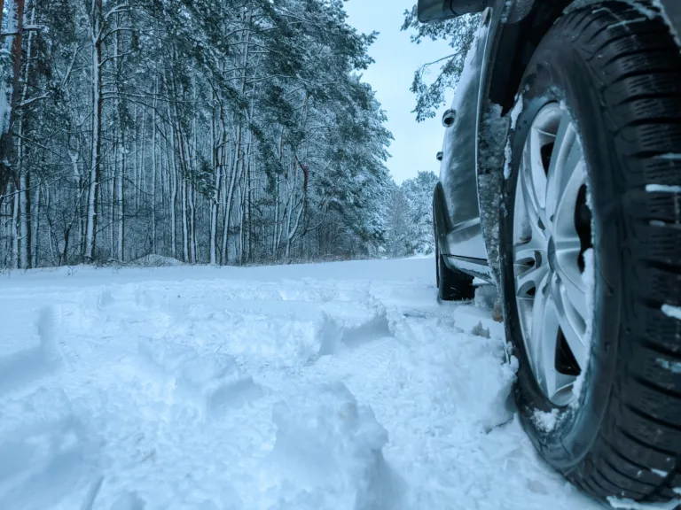 Car tires in the snow close-up. Winter tires as the basis of travel safety in the winter season. High quality photo