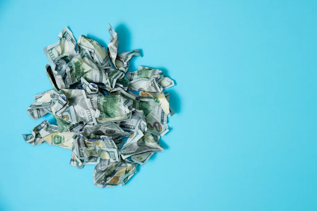 crumpled money on a blue background