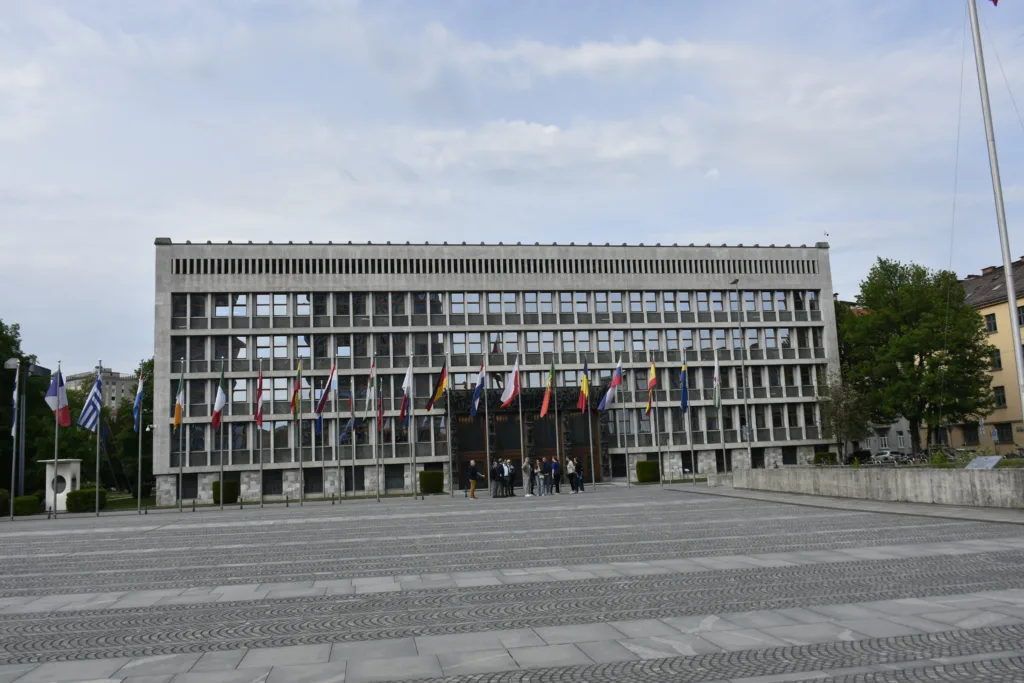 Ljubljana, Slovenia - April 28, 2026: Slovenian Parliament Building exterior, people walking, talking to one another view