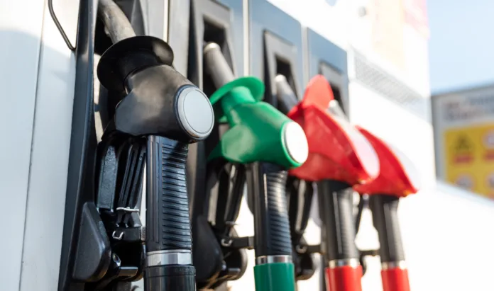 petrol-pump-filling-nozzles-fuel-at-gas-station-close-up-stockpack-istock Petrol pump filling nozzles. Fuel at gas station close up