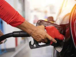 Refueling the car at a gas station fuel pump. Man driver hand refilling and pumping gasoline oil the car with fuel at he refuel station. Car refueling on petrol station. Fuel pump at station