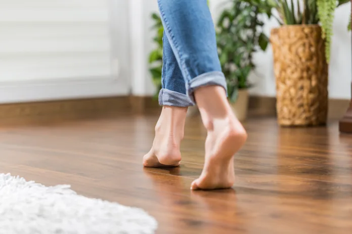 floor-heating-young-woman-walking-in-the-house-on-the-warm-floor-gently-walked-the-wooden-panels-stockpack-istock Floor heating. Young woman walking in the house on the warm floor. Gently walked the wooden panels.