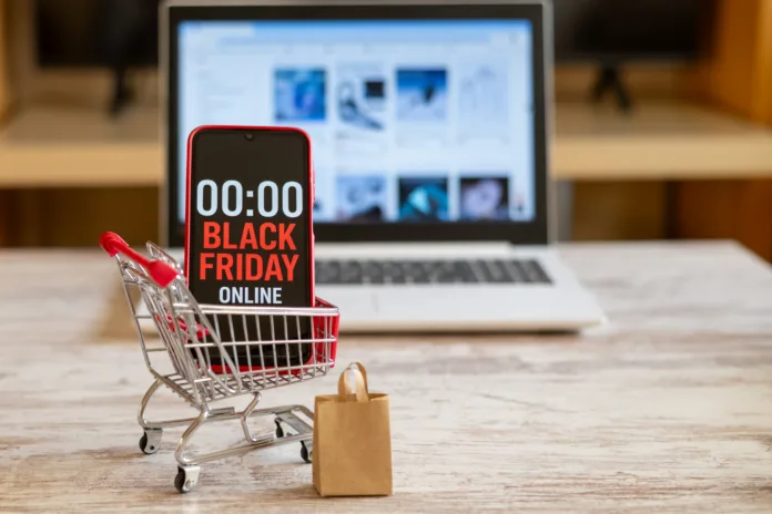 shopping-cart-with-smartphone-showing-black-friday-online-countdown-with-a-laptop-displaying-an-online-store-in-the-background-represents-online-shopping-and-discounts-stockpack-istock Shopping cart with smartphone showing black friday online countdown with a laptop displaying an online store in the background represents online shopping and discounts