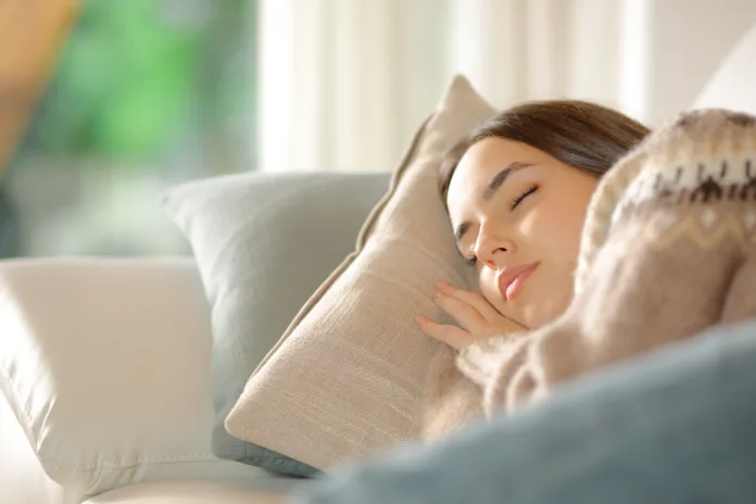 woman-sleeping-lying-on-a-couch-at-home-stockpack-istock Woman sleeping lying on a couch at home